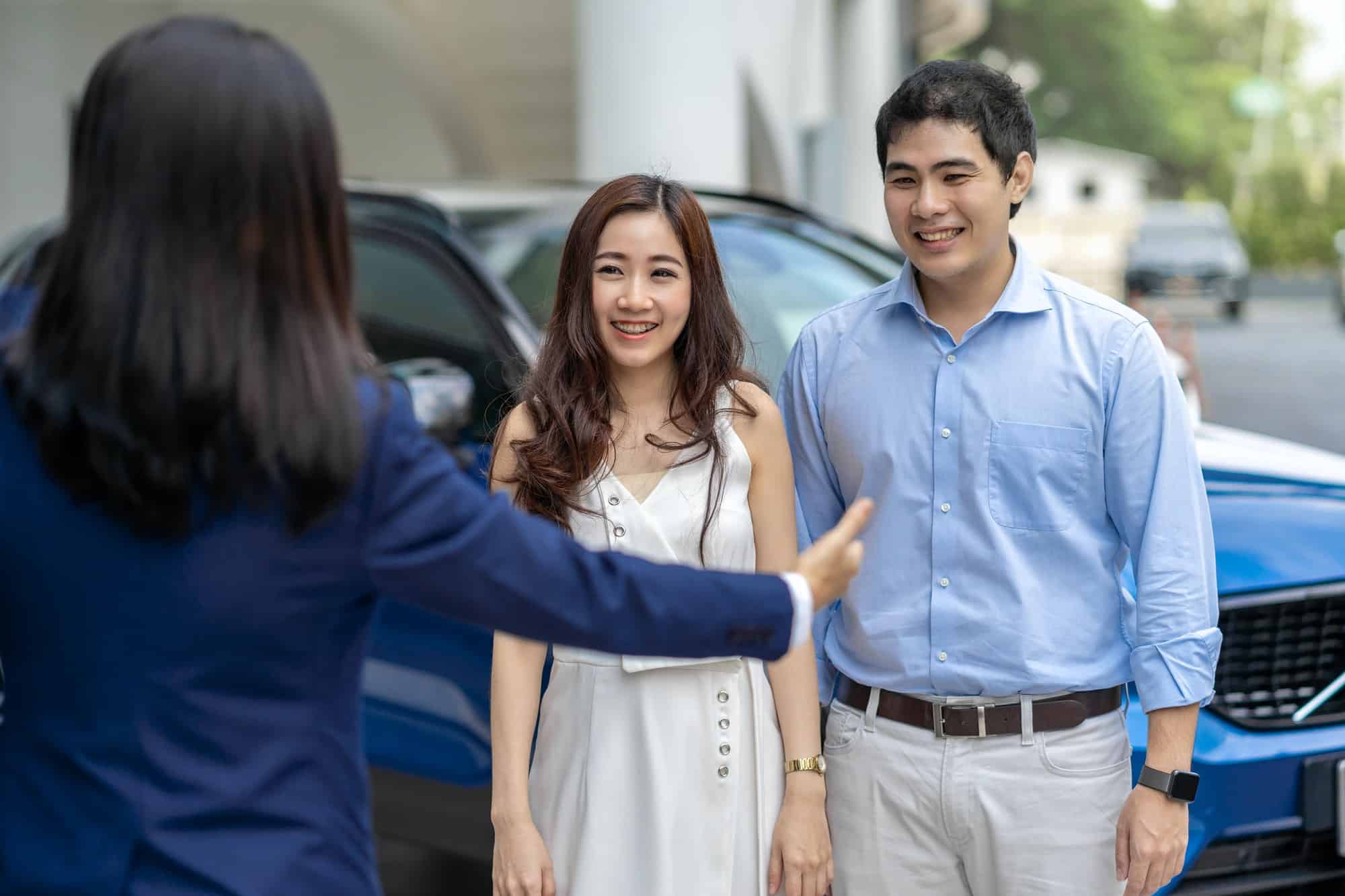 asian-saleswoman-welcoming-the-couple-customer-to-checking-the-car-infront-of-showroom.jpg asian-saleswoman-welcoming-the-couple-customer-to-checking-the-car-infront-of-showroom.jpg